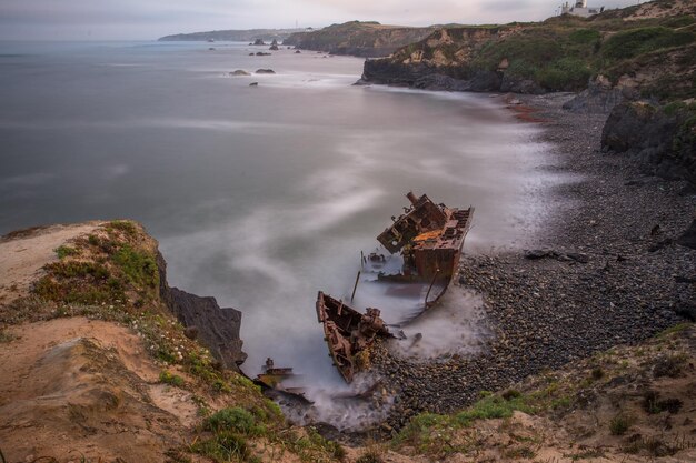 Old stranded boat falling apart with the constant waves