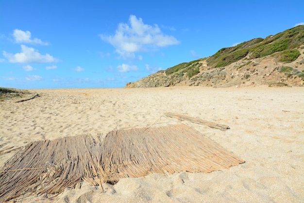 Old straw mat on the sand