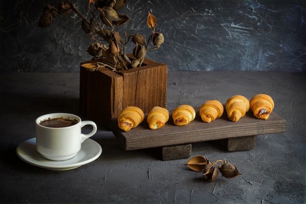 Old style still life with croissants and a cup of coffee