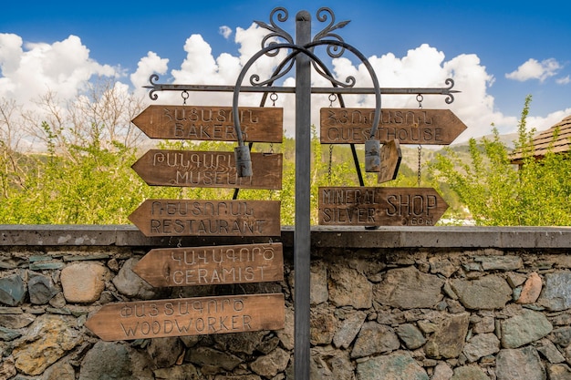 Old style wooden direction signs at Old Dilijan hotel on Sharambeyan street in Dilijan Armenia