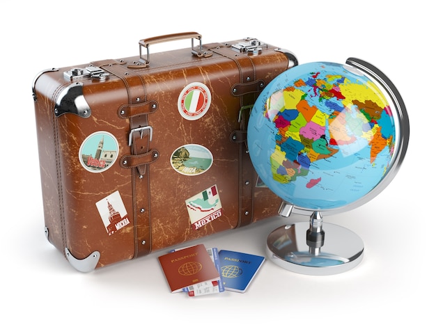 Old suitcase with stickers globe and passports with boarding pass tickets