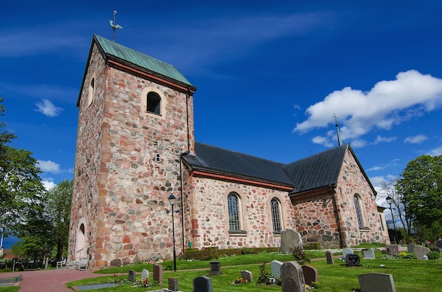 Old sweden church with cemetery in small town near Stockholm - Vallentuna, vivid natural outdoor Sweden background