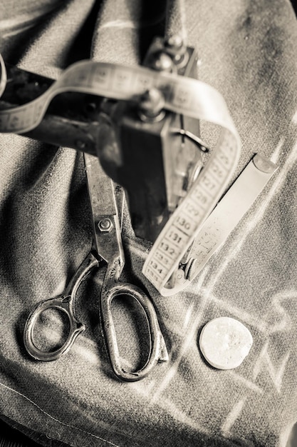 Old tailor machine with scissors threads and cloth