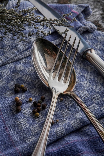 old tarnished silver cutlery on a tea towel