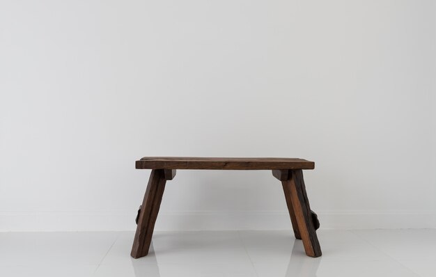 Old teak wood chair in white room interior