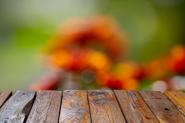 Old teak wood empty table in front of colorful bokeh background for display of product