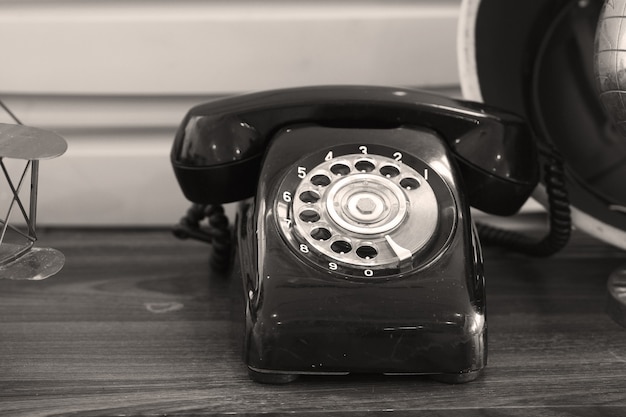 An old telephon with rotary dial,sepia photo