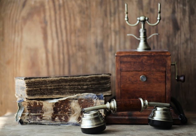 Old telephone and retro book on a wooden table