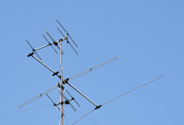 Old televisions antenna on blue sky