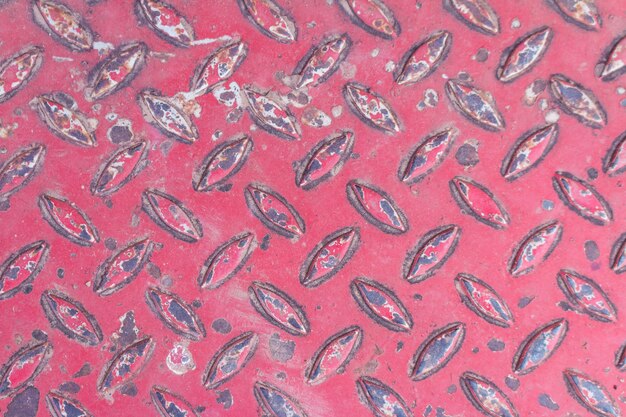Old Texture of metal diamond plate in red color is rust background