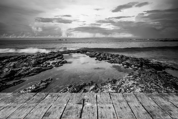 Old Textured Wooden Top Against Rocky Seashore