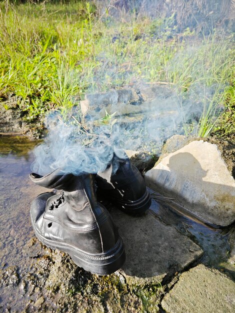 Old thrown away leather boot on flame in the farm