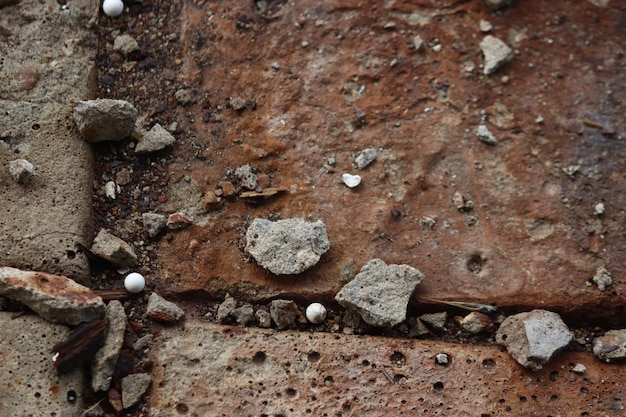 on the old tiles on the ground rust dust and white plastic airsoft balls