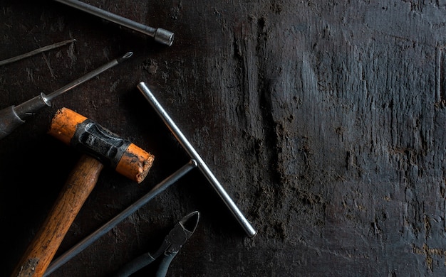 Old tools on black wooden floor background