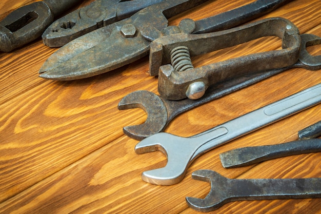 Photo old tools stacked before work on vintage wood space