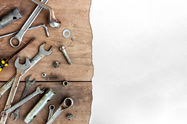 Old tools and white paper on wooden floor background