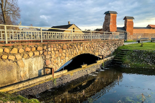 Old town bridge of stone over river.