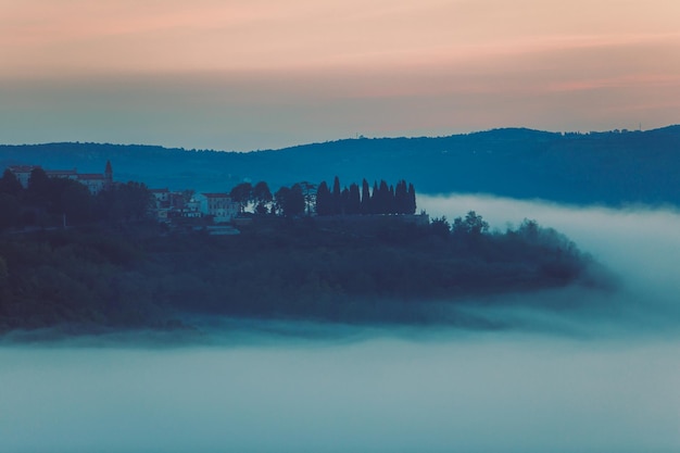 Old town on the top of the hill with castle clouds under it