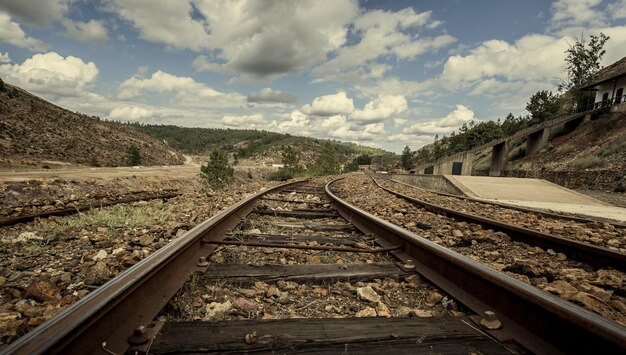 Old tracks of the mining train between mountains in Zarandas station