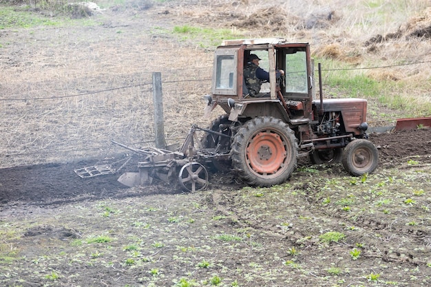 Old tractor riding in the highlands. Agriculture.