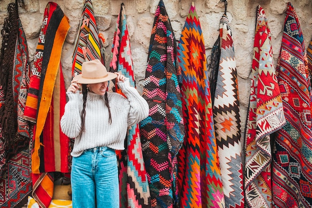 Old traditional turkish carpet shop in cave house cappadocia turkey kapadokya young woman on vacatio...