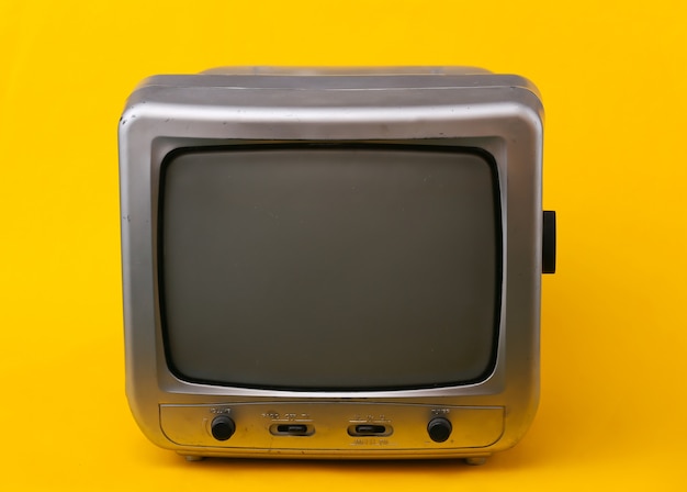 Old tv receiver on a yellow.