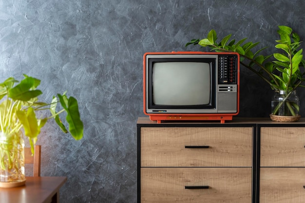 Old TV on a wooden cabinet in the room of the house Loft wall Warm atmosphere