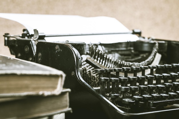 Old typewriter and books, close-up view