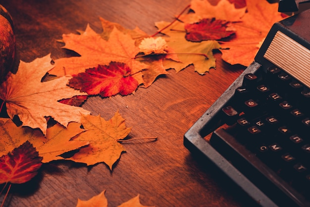 Old typewriter with leaves. concept autumn