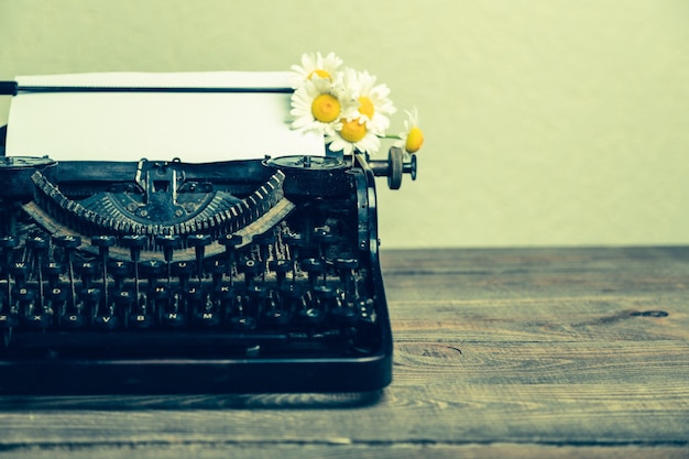 Old typewriter with paper  on table background