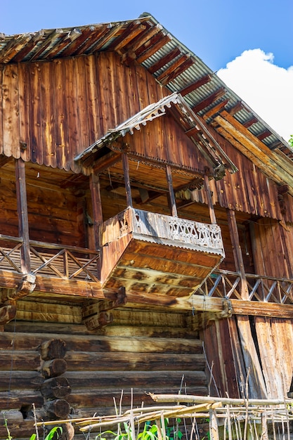 Old typical wooden Turkish village houses in green meadow in Artvin, Turkey