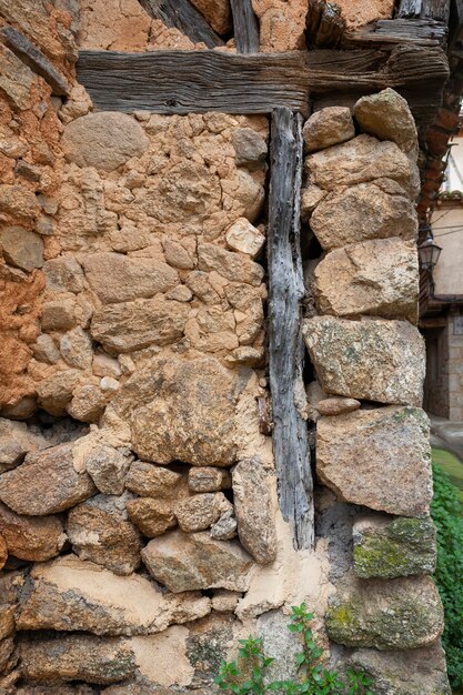 Old uncovered wall of a half-timbered house with adobe bricks and wooden beams sample of traditional local architecture, houses