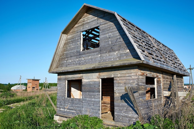 Old unfinished wooden house in village