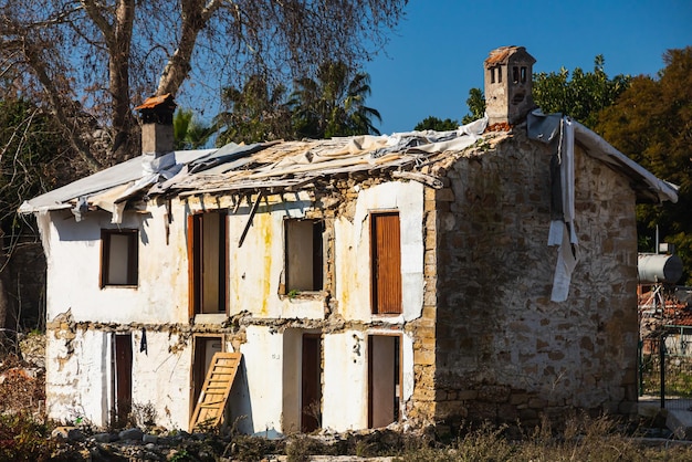 Old uninhabitable ruined house without windows and doors