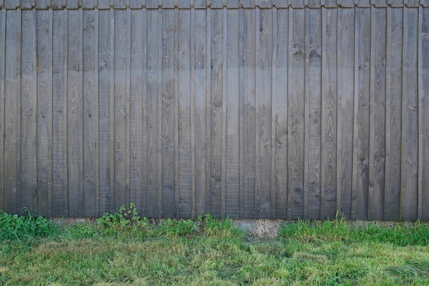 Old urban wood wall grunge background and green floor