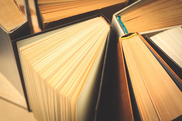 Old and used hardback books or text books seen from above.