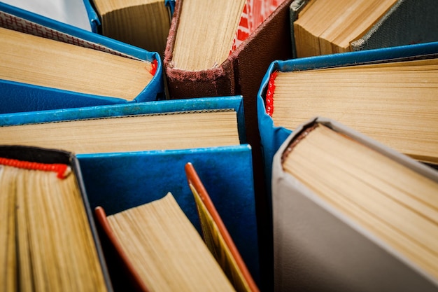 Old and used hardback books, top view.