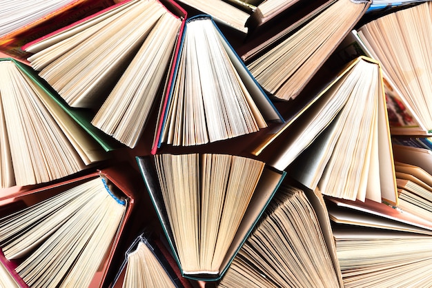 Old and used hardcover books or text books seen from above.