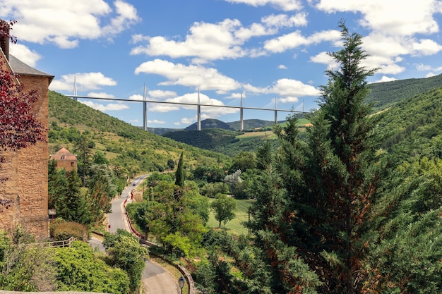 Old valley road D41 enters Peyre village and Millau Viaduct Aveyron Occitania Southern France