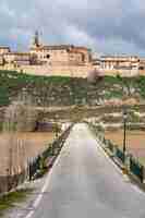 Photo an old village located in a ravine next to the lake that is crossed by a stone bridge maderuelo spain