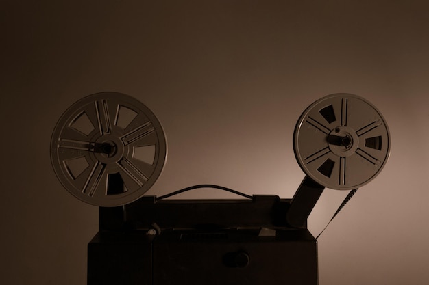 Old vintage 8mm projector with film reels and film frames copy\
space selective focus