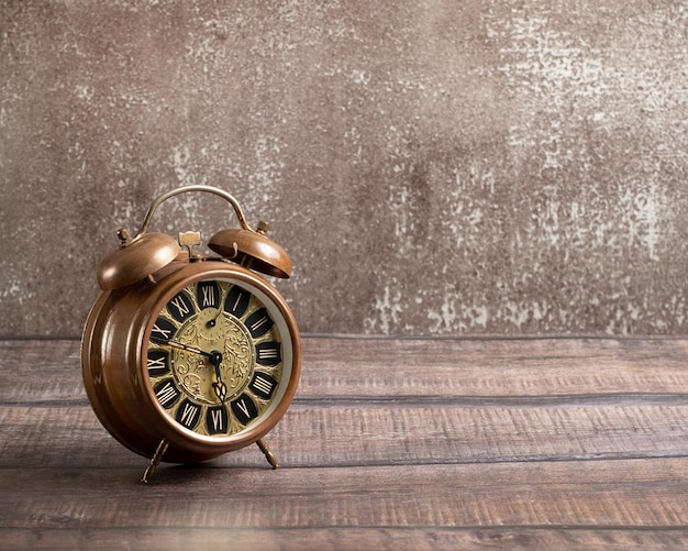 Old vintage alarm on a brown background