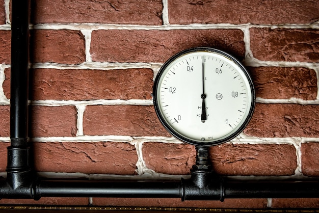 Old vintage analog manometer on steam power machine. Industrial theme