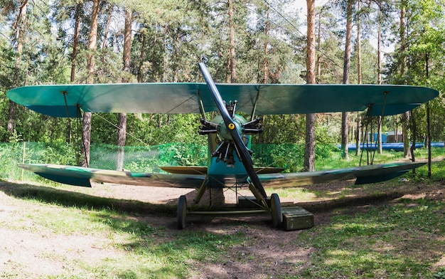 Old vintage biplane on a forest airfield