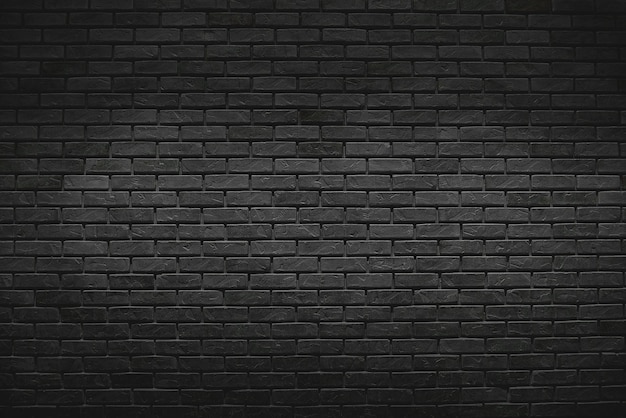 Photo the old vintage black brick wall background with gradient light on surface