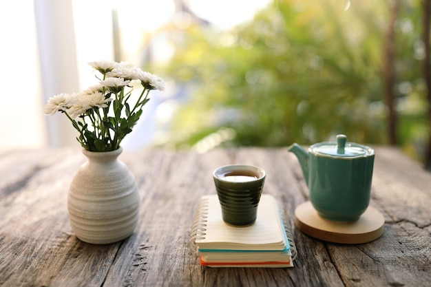 Old vintage ceramic cup and tea pot with white chrysanthemum vase