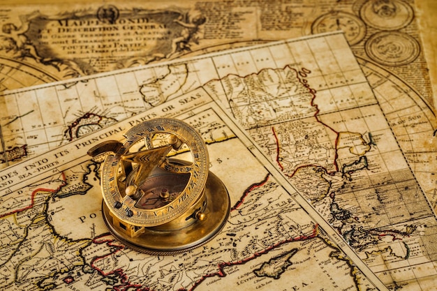 Old vintage compass on ancient map