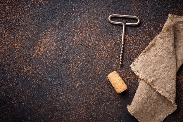 Old vintage corkscrew and wine cork 