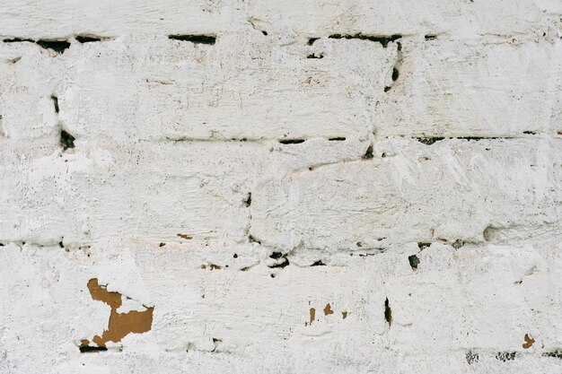 Old vintage grunge red brick wall with shabby white plaster for background Abstract texture