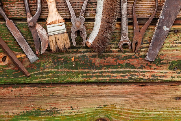 Old vintage hand tools on wooden background